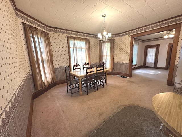 506 E Lincoln St, Saybrook, IL 61770 - carpeted dining space with ornamental molding, wallpapered walls, and a chandelier