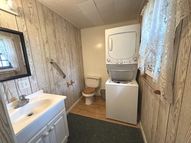 506 E Lincoln St, Saybrook, IL 61770 - bathroom with estacked washer and dryer, vanity, and wooden walls