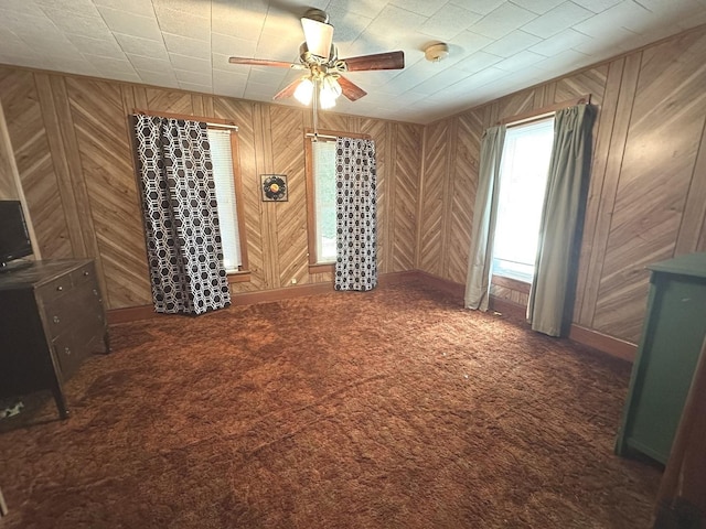 506 E Lincoln St, Saybrook, IL 61770 - carpeted empty room with a ceiling fan, wooden walls, and a smoke detector