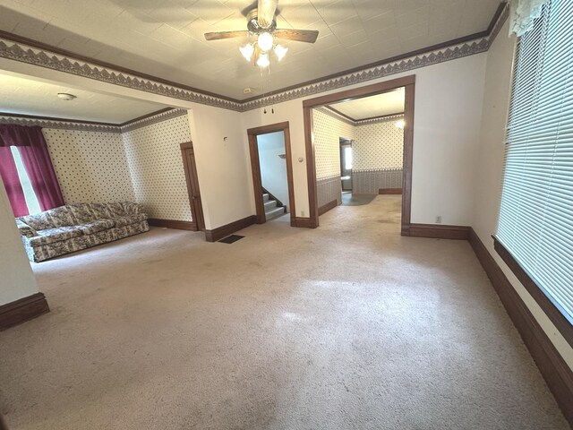 506 E Lincoln St, Saybrook, IL 61770 - unfurnished room featuring wallpapered walls, ornamental molding, light carpet, plenty of natural light, and a ceiling fan