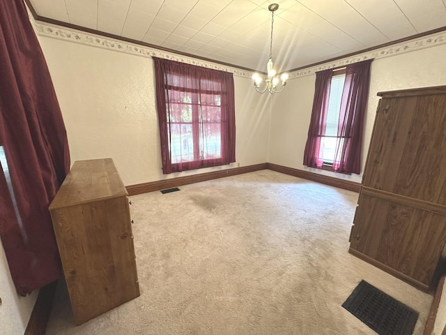 506 E Lincoln St, Saybrook, IL 61770 - spare room with carpet, a chandelier, a textured wall, and ornamental molding