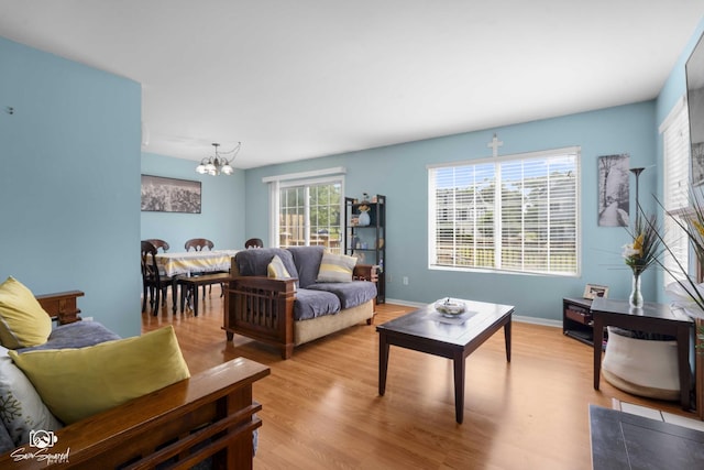 1644 Bridle Post Dr Unit 1644, Aurora, IL 60506 - living area with a chandelier and light wood-style flooring