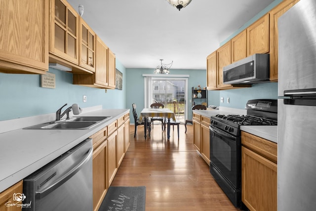 1644 Bridle Post Dr Unit 1644, Aurora, IL 60506 - kitchen with appliances with stainless steel finishes, wood finished floors, light countertops, and glass insert cabinets
