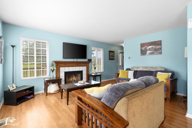 1644 Bridle Post Dr Unit 1644, Aurora, IL 60506 - living area with light wood-type flooring and a tiled fireplace