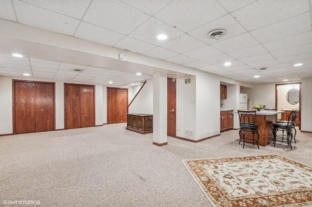 9228 S 55th Ct, Oak Lawn, IL 60453 - finished below grade area featuring light colored carpet, a paneled ceiling, wet bar, recessed lighting, and freestanding refrigerator