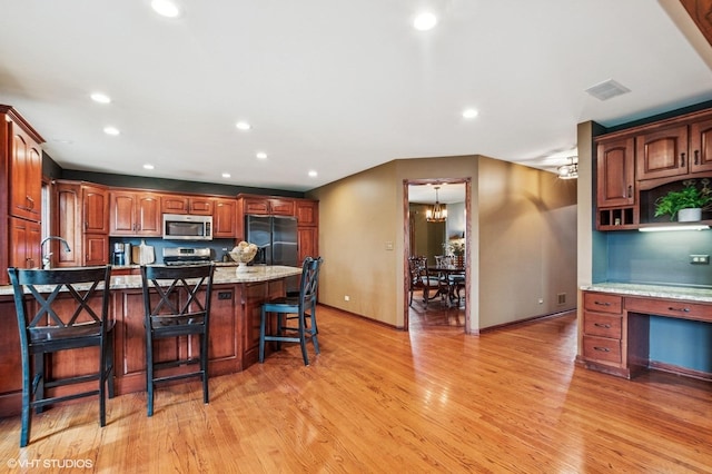 9228 S 55th Ct, Oak Lawn, IL 60453 - kitchen with stainless steel appliances, light wood-style floors, a kitchen bar, recessed lighting, and a peninsula
