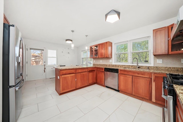 2747 Perry Rd, Flossmoor, IL 60422 - kitchen with appliances with stainless steel finishes, brown cabinets, a peninsula, glass insert cabinets, and light stone countertops