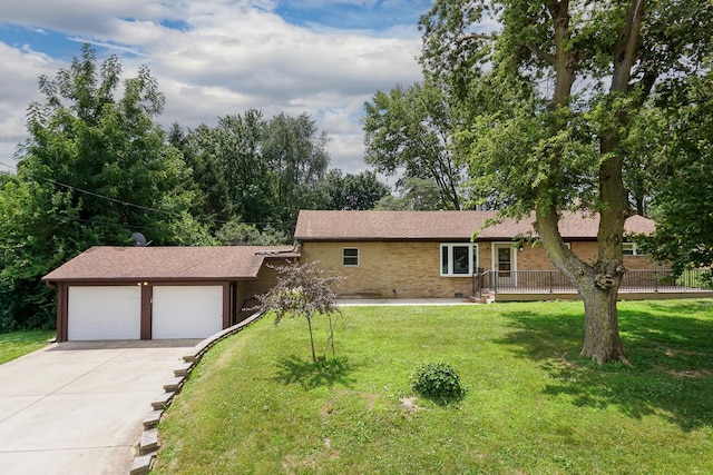 116 W C St, Delavan, IL 61734 - view of front of property with an attached garage, concrete driveway, a front lawn, and brick siding