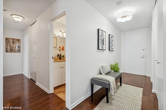 3660 N Lake Shore Dr Unit 4502, Chicago, IL 60613 - hallway with wood finished floors, a textured ceiling, and a chandelier