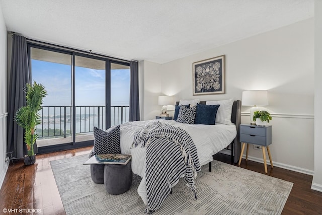 3660 N Lake Shore Dr Unit 4502, Chicago, IL 60613 - bedroom with access to outside, wood finished floors, expansive windows, and a water view