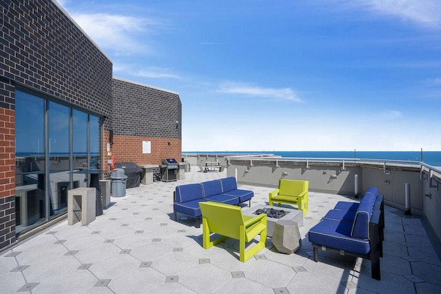 3660 N Lake Shore Dr Unit 4502, Chicago, IL 60613 - view of patio with an outdoor living space with a fire pit, a water view, and grilling area