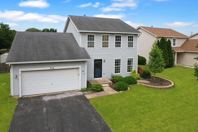 256 Stamford Ln, Romeoville, IL 60446 - colonial house featuring driveway, an attached garage, a front yard, and roof with shingles