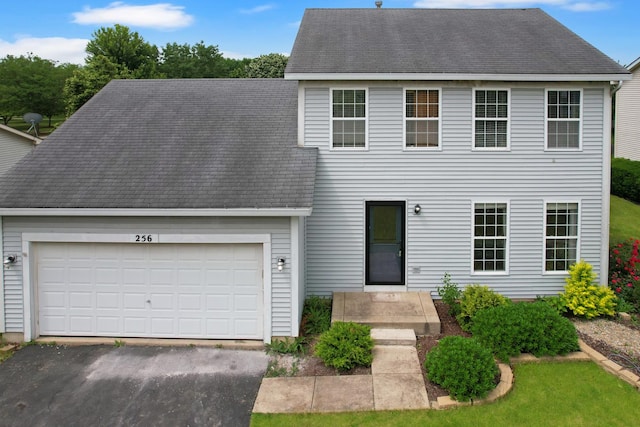 256 Stamford Ln, Romeoville, IL 60446 - colonial home featuring an attached garage, asphalt driveway, and roof with shingles