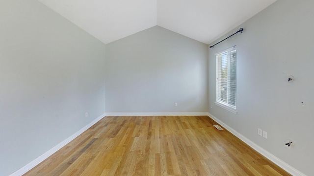 256 Stamford Ln, Romeoville, IL 60446 - empty room featuring light wood finished floors and vaulted ceiling