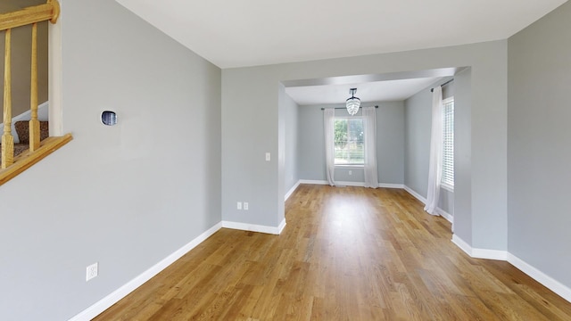 256 Stamford Ln, Romeoville, IL 60446 - unfurnished room with wood finished floors, stairway, and a chandelier