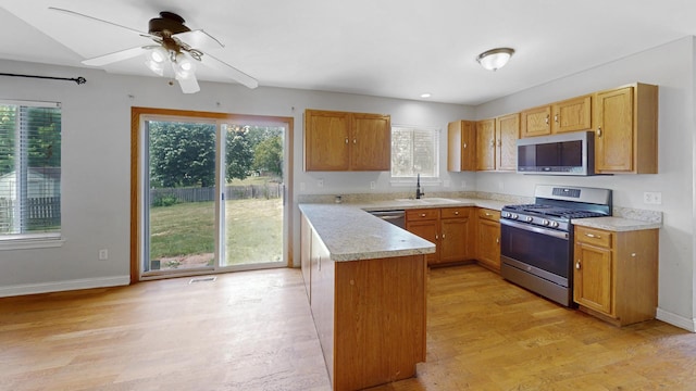 256 Stamford Ln, Romeoville, IL 60446 - kitchen with stainless steel appliances, light wood-style flooring, light countertops, a peninsula, and recessed lighting