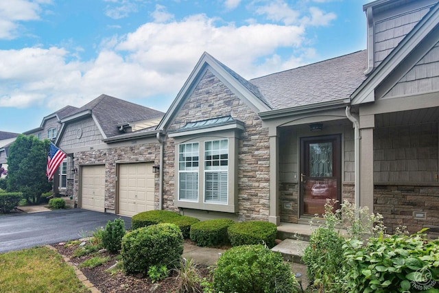 1288 Seabury Cir, Carol Stream, IL 60188 - doorway to property with stone siding, a garage, asphalt driveway, and a shingled roof
