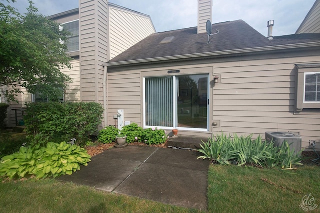 1288 Seabury Cir, Carol Stream, IL 60188 - rear view of property featuring a chimney, a patio, and roof with shingles