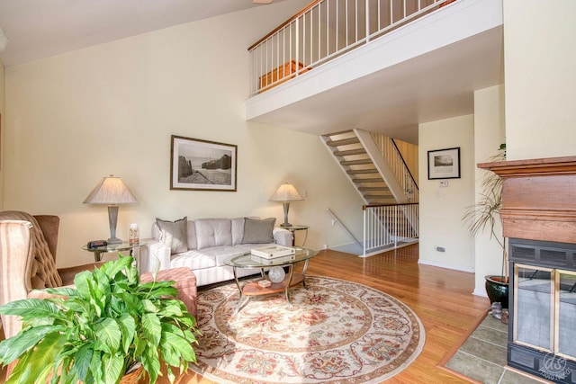 1288 Seabury Cir, Carol Stream, IL 60188 - living room with stairway, wood finished floors, a glass covered fireplace, and a high ceiling