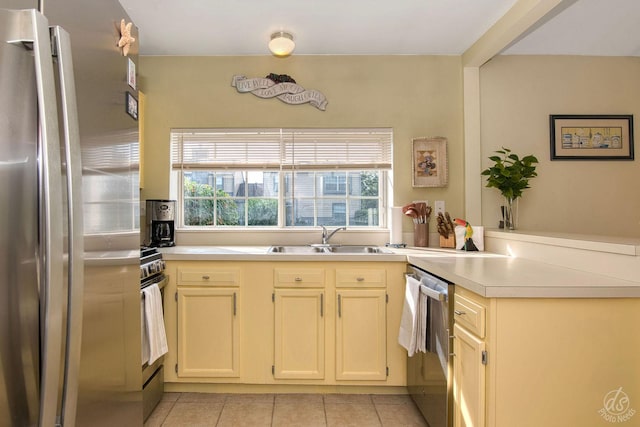 1288 Seabury Cir, Carol Stream, IL 60188 - kitchen featuring stainless steel appliances, a peninsula, light tile patterned floors, light countertops, and cream cabinetry