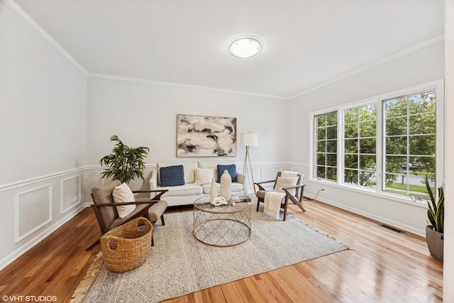 1040 E Buckingham Dr, Naperville, IL 60563 - living area featuring crown molding, wood finished floors, and wainscoting