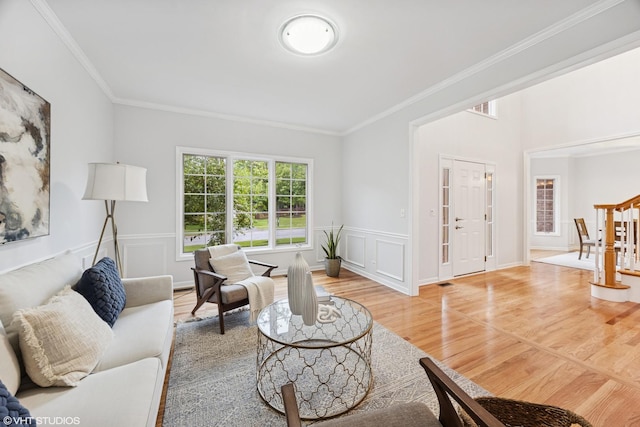 1040 E Buckingham Dr, Naperville, IL 60563 - living room with light wood finished floors, crown molding, and a wainscoted wall