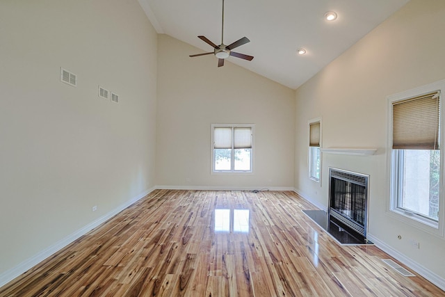 200 Ahmed Ct, Glendale Heights, IL 60139 - unfurnished living room featuring plenty of natural light, light wood-type flooring, high vaulted ceiling, a fireplace, and ceiling fan