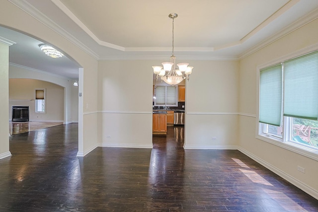 200 Ahmed Ct, Glendale Heights, IL 60139 - unfurnished room with plenty of natural light, a chandelier, arched walkways, dark wood-style floors, and ornamental molding