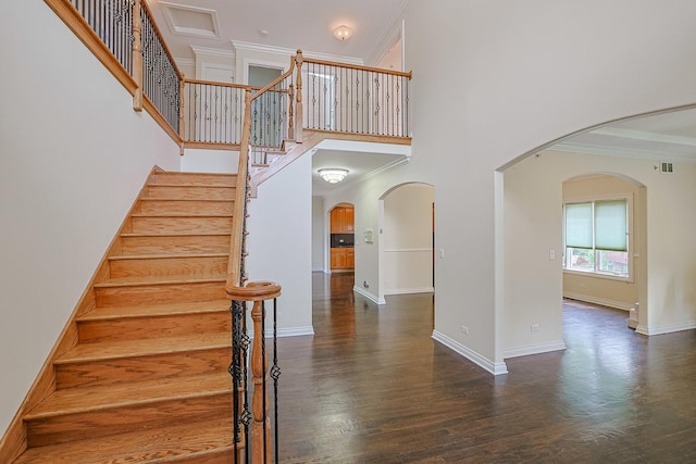 200 Ahmed Ct, Glendale Heights, IL 60139 - stairway featuring arched walkways, crown molding, wood finished floors, and a towering ceiling