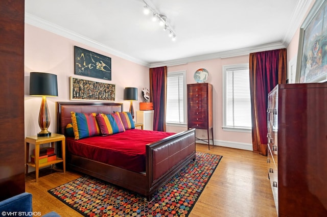 1116 W N Shore Ave Unit 2, Chicago, IL 60626 - bedroom featuring wood finished floors, crown molding, and track lighting