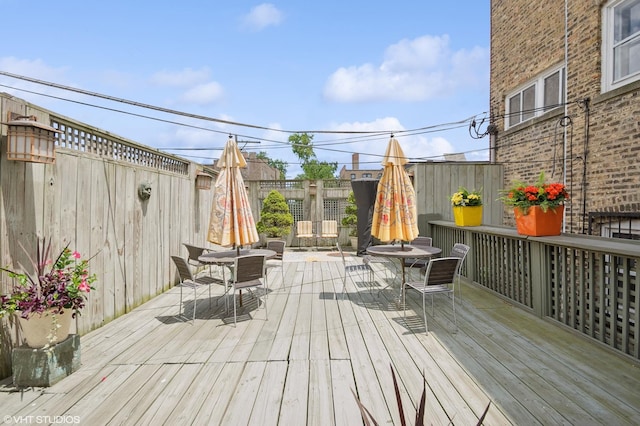 1116 W N Shore Ave Unit 2, Chicago, IL 60626 - wooden terrace featuring outdoor dining area