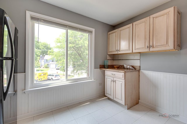 923 Manchester Cir Unit 923, Schaumburg, IL 60193 - laundry room featuring cabinet space, wainscoting, plenty of natural light, and light tile patterned flooring