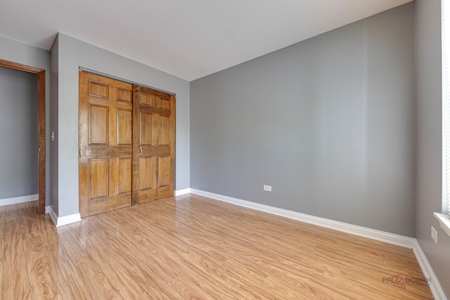 923 Manchester Cir Unit 923, Schaumburg, IL 60193 - unfurnished bedroom with light wood-style floors and a closet