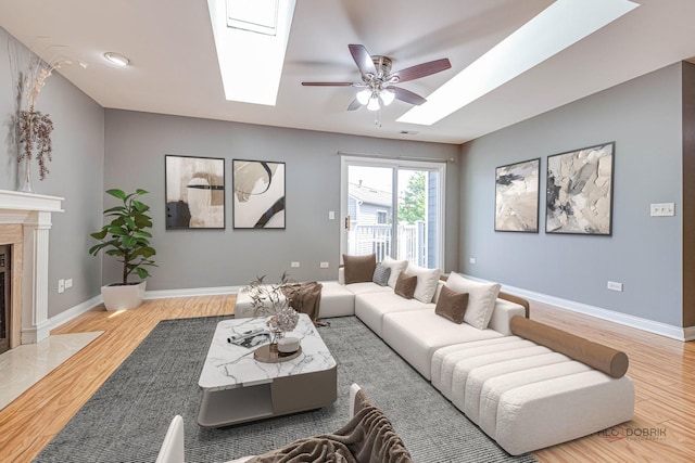 923 Manchester Cir Unit 923, Schaumburg, IL 60193 - living area with a skylight, a ceiling fan, wood finished floors, and a premium fireplace