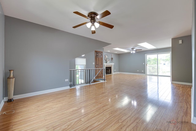 923 Manchester Cir Unit 923, Schaumburg, IL 60193 - empty room with ceiling fan, light wood-type flooring, and a skylight