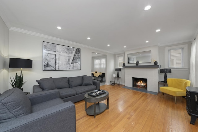 3043 W 96th Pl, Evergreen Park, IL 60805 - living room with light wood-style floors, recessed lighting, a tiled fireplace, and crown molding