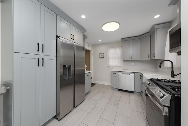 3043 W 96th Pl, Evergreen Park, IL 60805 - kitchen featuring stainless steel appliances, light countertops, gray cabinets, recessed lighting, and decorative backsplash