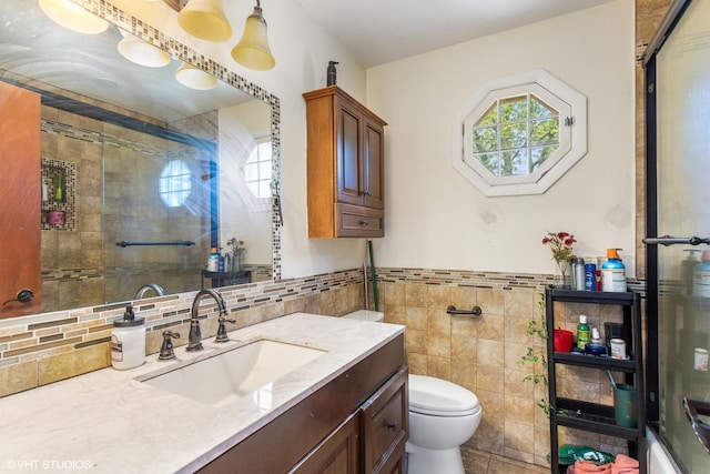 852 Pamela Dr, Bensenville, IL 60106 - bathroom featuring tile walls, vanity, tiled shower, and wainscoting