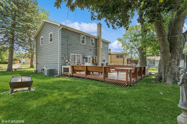 852 Pamela Dr, Bensenville, IL 60106 - rear view of house with a chimney, a deck, and a lawn