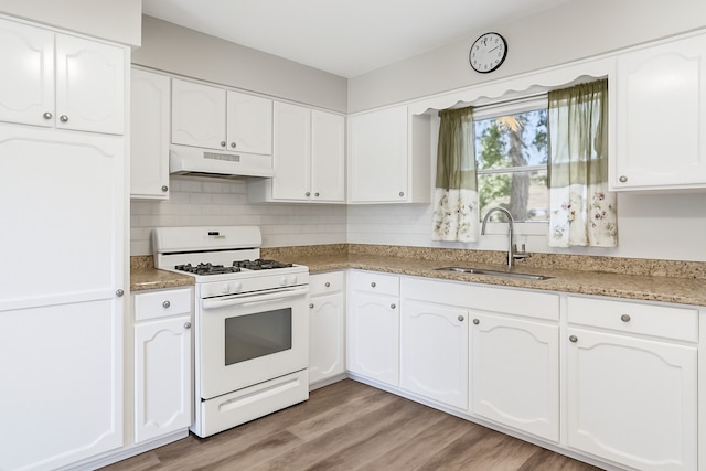 852 Pamela Dr, Bensenville, IL 60106 - kitchen with white gas range, under cabinet range hood, white cabinets, light wood-type flooring, and tasteful backsplash
