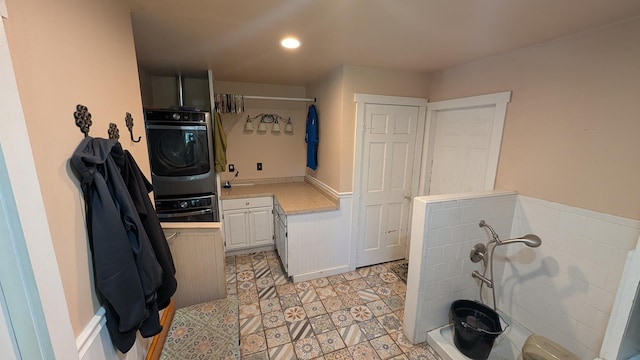 5N119 Mary Ct, Saint Charles, IL 60175 - laundry room featuring stacked washer / drying machine, cabinet space, and recessed lighting