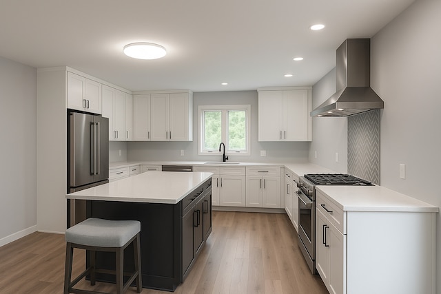 5N119 Mary Ct, Saint Charles, IL 60175 - kitchen featuring premium appliances, wall chimney exhaust hood, light wood-type flooring, a kitchen breakfast bar, and light countertops