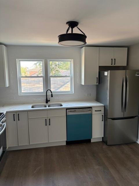 1405 N 24th Ave, Melrose Park, IL 60160 - kitchen featuring stainless steel appliances, dark wood-type flooring, light countertops, and white cabinetry