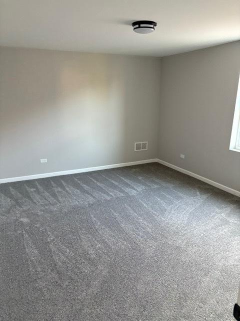 1405 N 24th Ave, Melrose Park, IL 60160 - spare room with baseboards and dark carpet