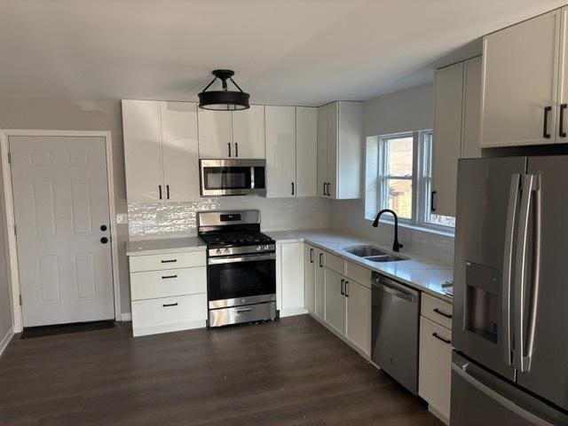 1405 N 24th Ave, Melrose Park, IL 60160 - kitchen featuring stainless steel appliances, light countertops, dark wood-type flooring, decorative backsplash, and white cabinets
