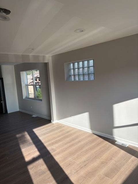 1405 N 24th Ave, Melrose Park, IL 60160 - empty room with baseboards and dark wood-style flooring