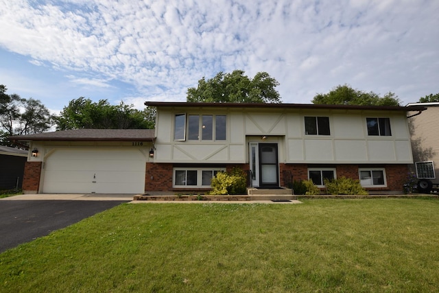 1116 Oakleaf Ave, Mchenry, IL 60051 - raised ranch featuring driveway, a front yard, an attached garage, brick siding, and stucco siding