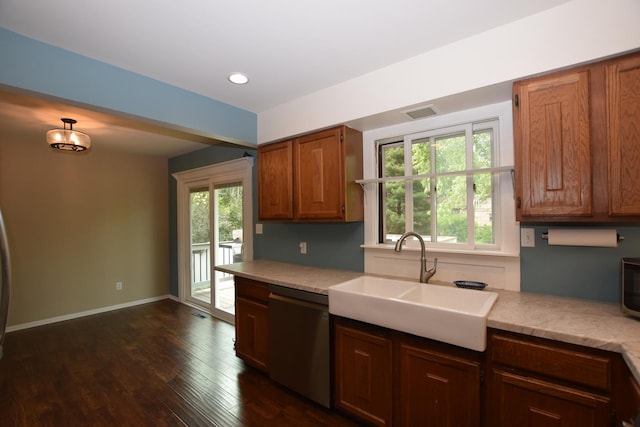 1116 Oakleaf Ave, Mchenry, IL 60051 - kitchen with stainless steel dishwasher, light countertops, dark wood-style flooring, brown cabinetry, and recessed lighting