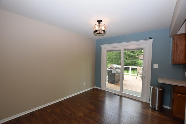 1116 Oakleaf Ave, Mchenry, IL 60051 - unfurnished dining area with dark wood-style flooring and baseboards