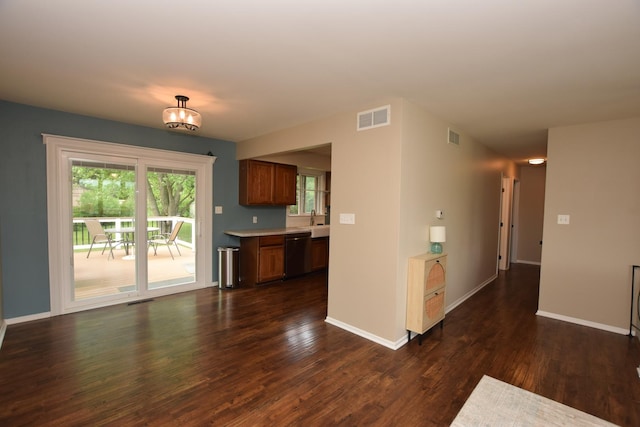 1116 Oakleaf Ave, Mchenry, IL 60051 - kitchen featuring stainless steel dishwasher, light countertops, dark wood-type flooring, and brown cabinets